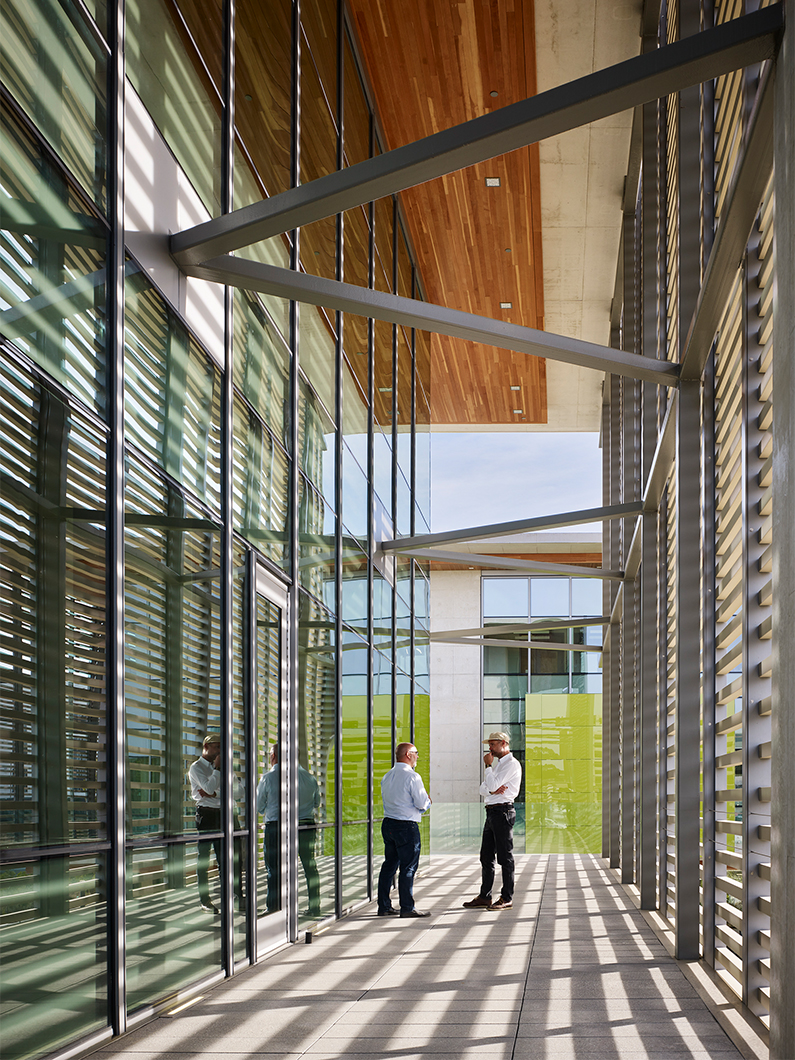 Covered exterior terrace with two men standing and talking