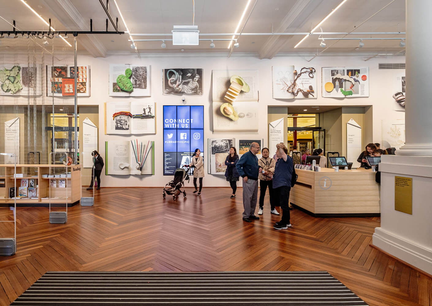 groups of families enjoy a library exhibit