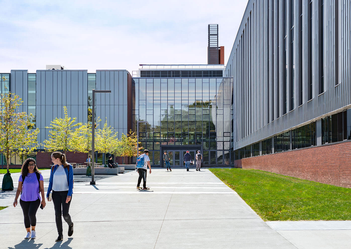 Students walking in front of the school's north-facing elevation.