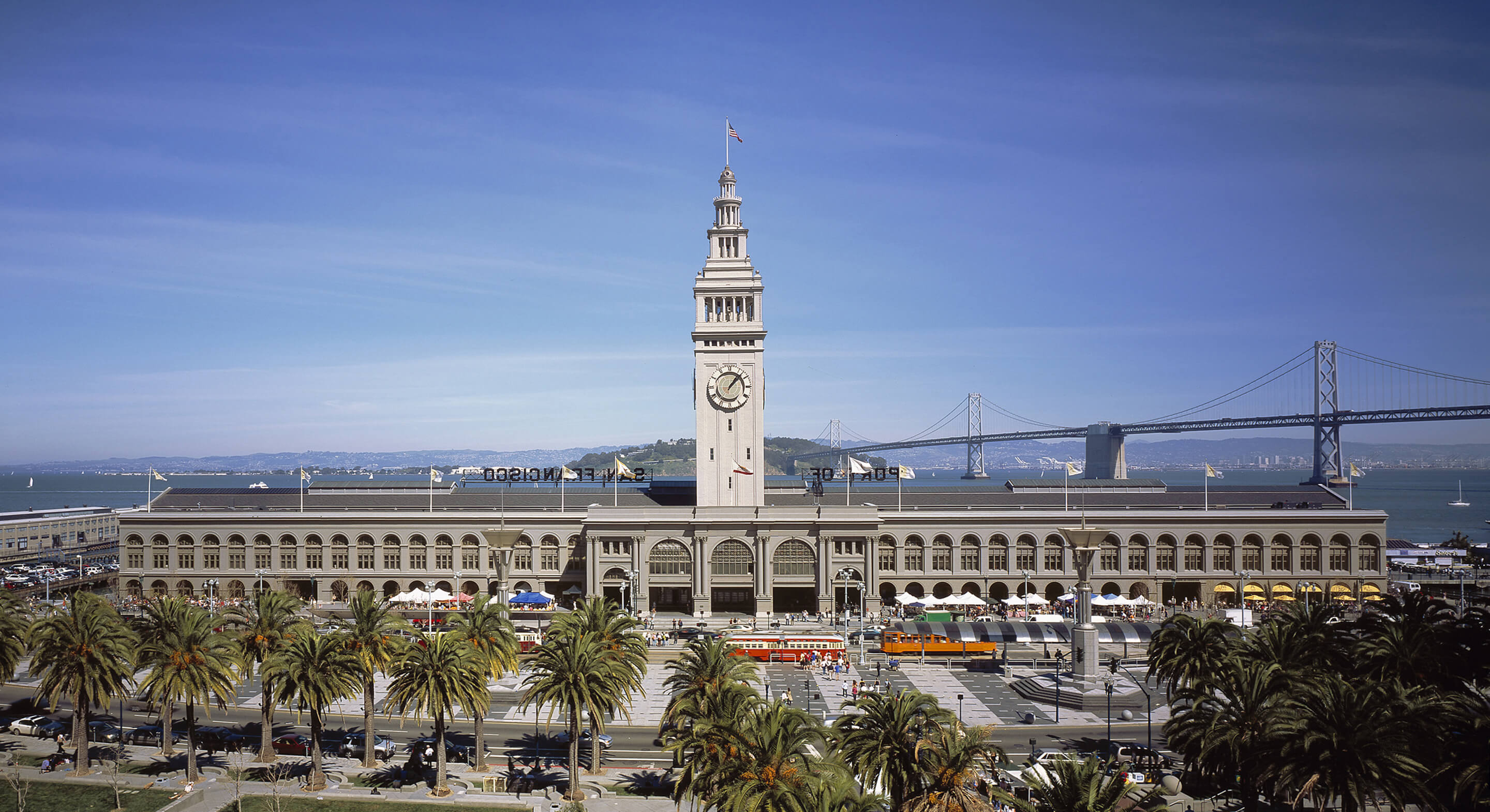 exterior of the ferry building with the bay bridge in the background