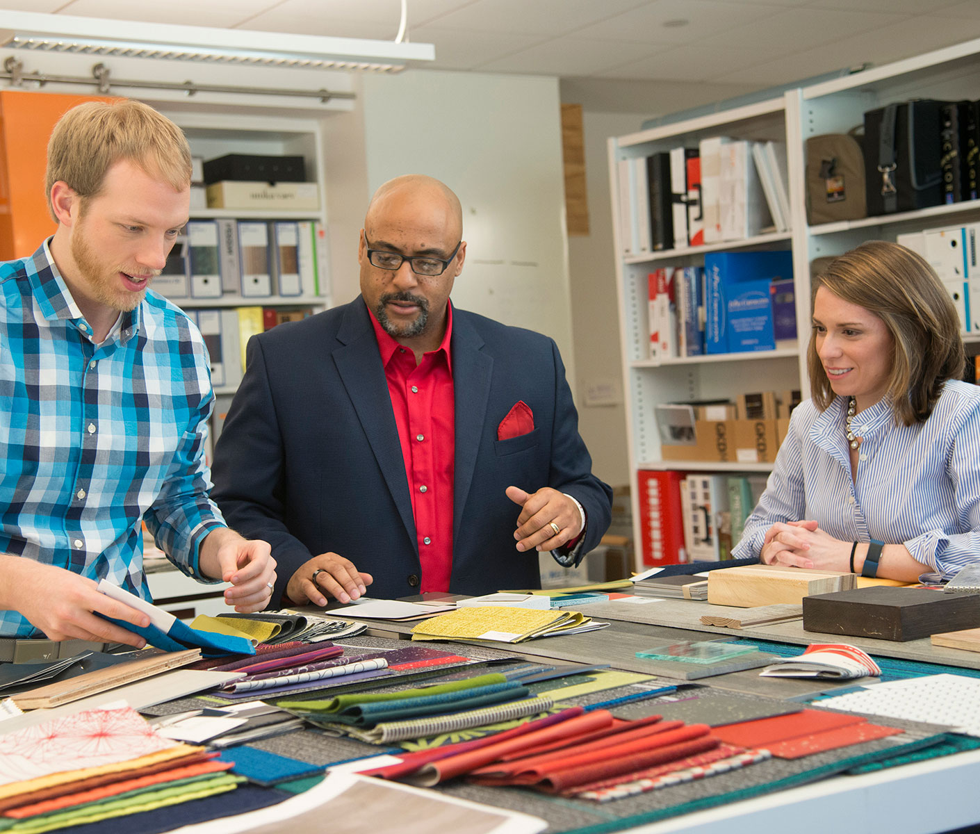 Team members looking at material swatches