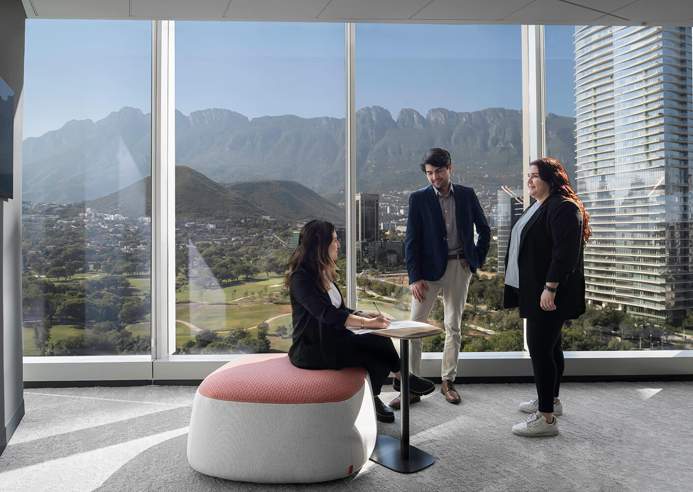 Team talking by a view to nature in the office.