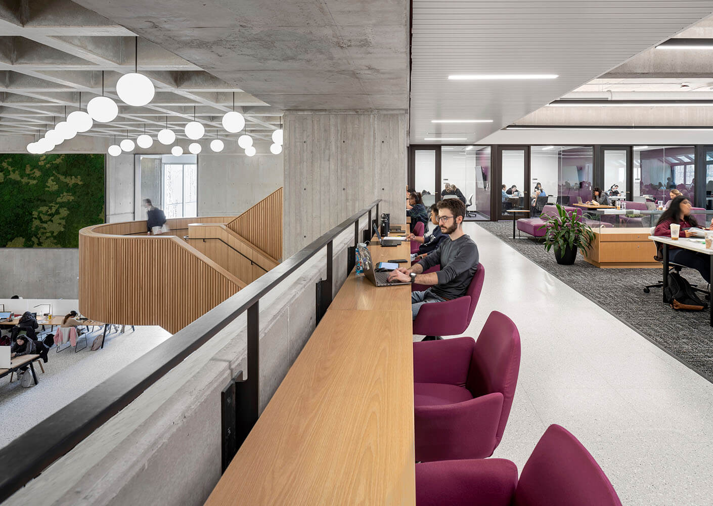 A view of the mezzanine, showing a long table with a person sitting at one of the seats overlooking the room